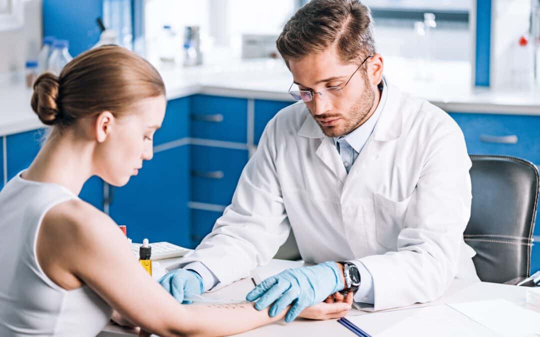 selective focus of handsome allergist holding ruler near marked hand of woman